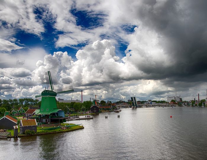 Dutch windmills and skies over river Zaan